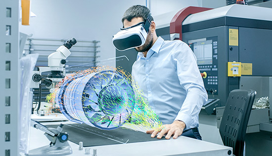 Lab engineer wearing a VR headset, looking at a holographic projection of an engine turbine on a table.