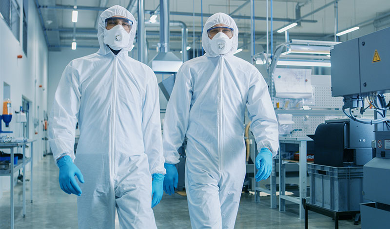 Two men in sterile suits
